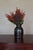 A small vintage stoneware jar in a deep olive-black glaze. Use it as a bud vase for a single stem or sprig of herbs, or...