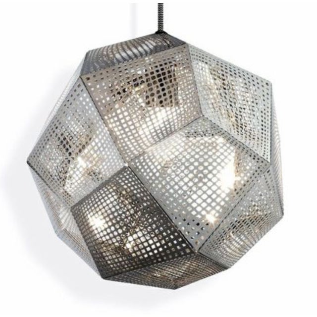 Discontinued Etch Pendants from Tom Dixon. Stainless finish with black/white covered cord. Each pendant is 10.8"H, 12.6"W,...