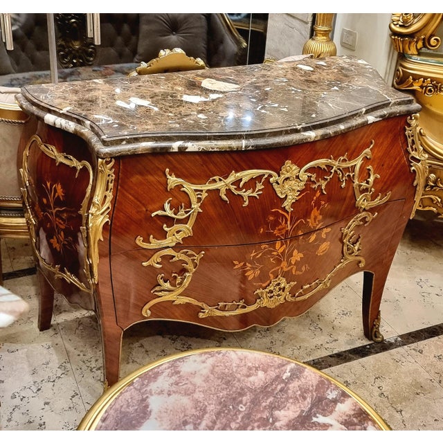 Make a statement with this magnificent French bombe commode, showcasing exceptional floral marquetry, graceful serpentine...