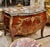 Make a statement with this magnificent French bombe commode, showcasing exceptional floral marquetry, graceful serpentine...