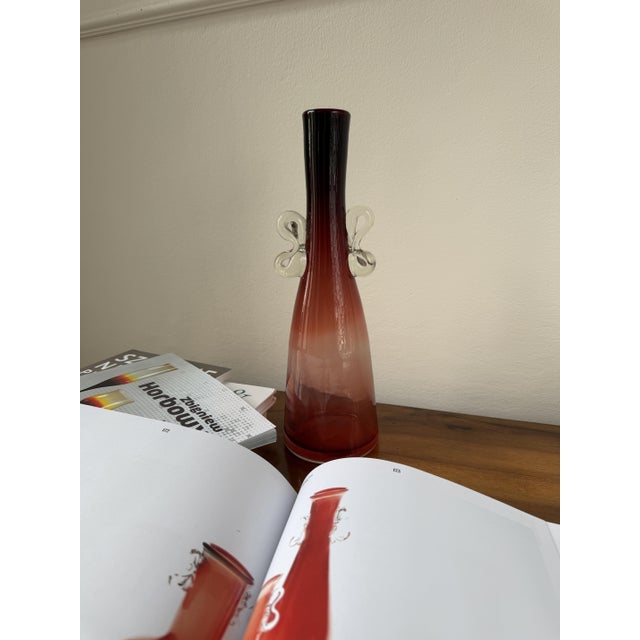 A tall bottle-form vase designed by Jerzy Słuczan-Orkusz for the Tarnowiec glassworks in southern Poland. In the Polish...