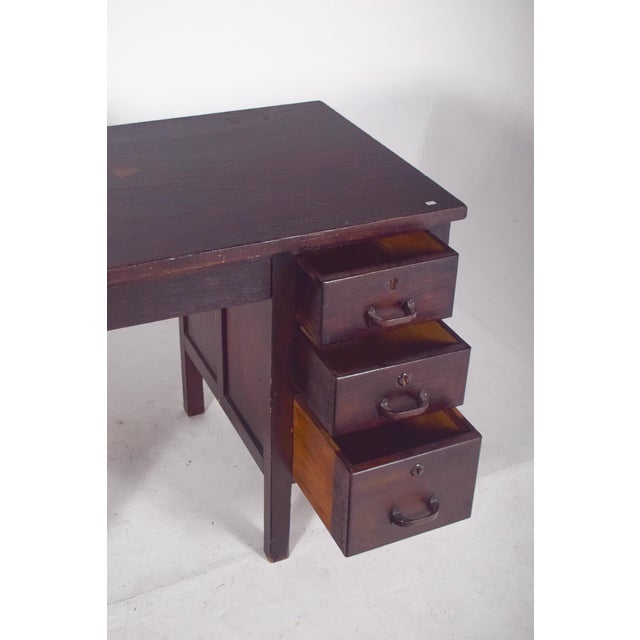 Portuguese desk from the first half of the 20th century. In dark wood, with a symmetrical and functional structure,...