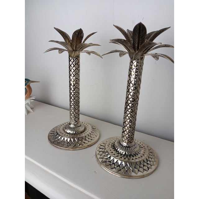 Set of palm tree-shaped candle holders for a vintage decor. Beautiful silver patina
