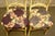 Pair of wooden French Country style chairs with cream coloring complemented by a graceful curving silhouette and a homey...