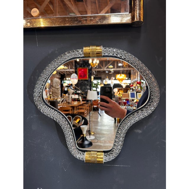 Elevate your space with our Vintage Italian Mid Century Murano Wall Mirror from the 1940s. This exquisite piece boasts a...