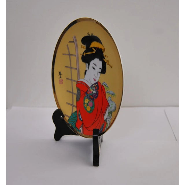 Japanese contemporary, Arita porcelain signed and stamped in kanji decorative, gilt art plate, featuring a Japanese Bijin-...