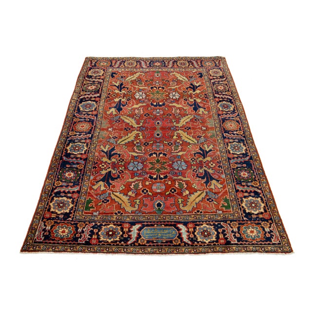 This exquisite antique Persian Heriz wool rug showcases a captivating motif in shades of blue, green, and soft yellow,...