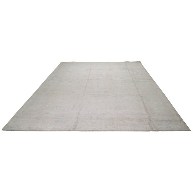 Hand-knotted with care using traditional rug making techniques, this wool rug blends timeless craftsmanship with a modern...