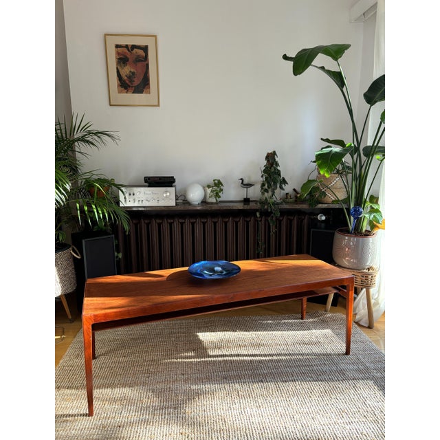 A beautiful signed teak table in perfect condition. The original designer sticker is located underneath. This piece has an...