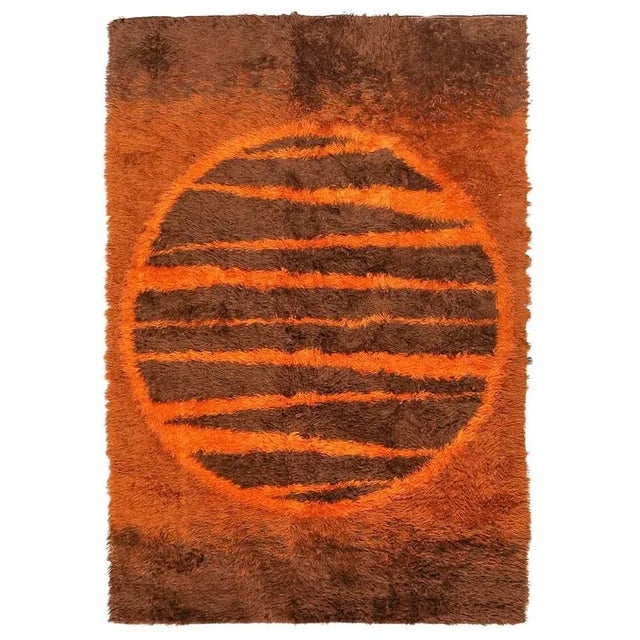 Post-Modern shag wool area rug with an abstract design resembling a sun featuring various shades of browns and burnt...