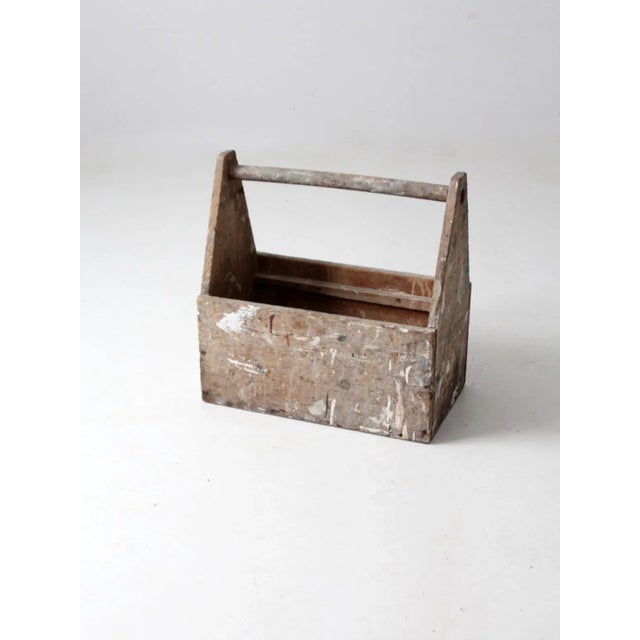 This is a vintage wooden trug. The rustic wood toolbox tote features a simple design accented with years of paint...
