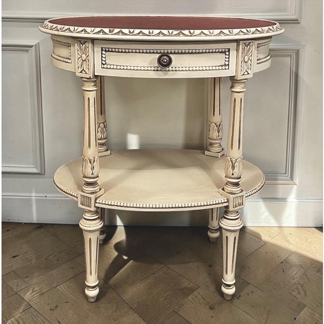 Graceful proportions and refined neoclassical detailing make this French Louis XVI painted side table an elegant accent...