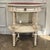 Graceful proportions and refined neoclassical detailing make this French Louis XVI painted side table an elegant accent...