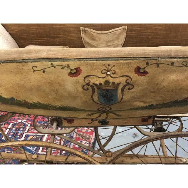 This charming 19th century continental perambulator has a canvas covered body mounted with two painted brass coats of...