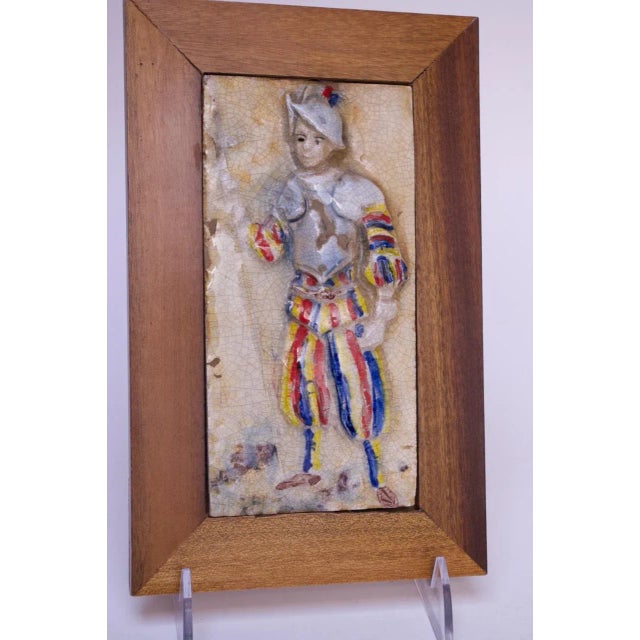 Circa 1950s terracotta and porcelain enamel decorative tiles depicting soldiers in traditional uniform. Hand made and...