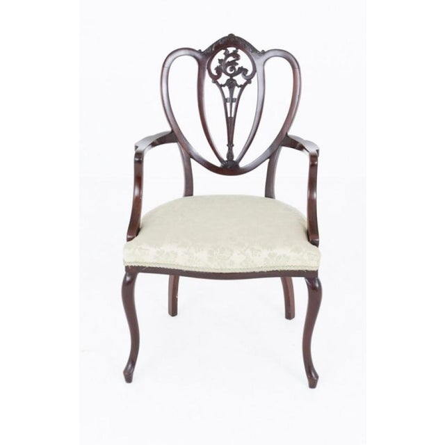 An attractive Hepplewhite Revival open mahogany armchair, standing on elegant shaped front legs with gracefully swept rear...