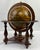 Vintage Italian globe featuring an Old World–style map with richly detailed zodiac and celestial motifs, set upon a turned...