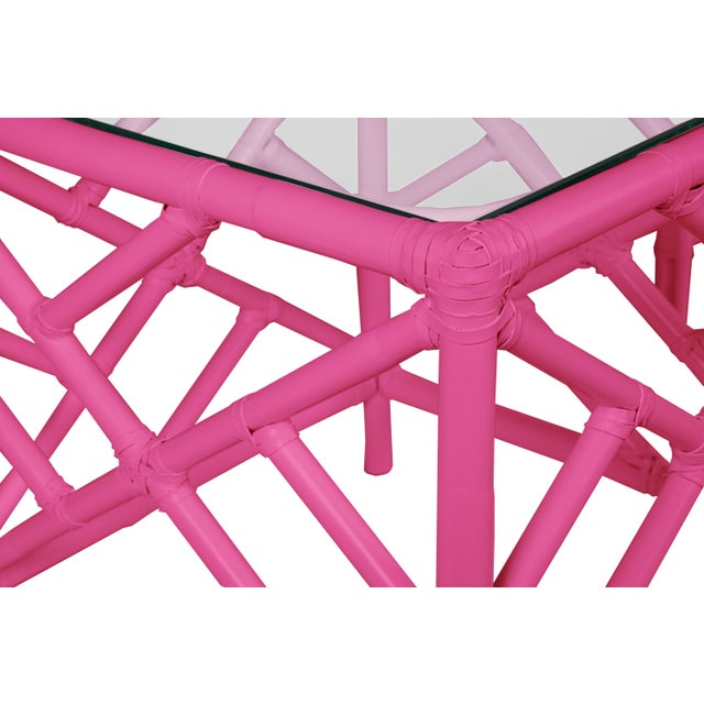 In a classic chinoiserie style, this set of two rattan nesting tables feature a rattan frame, rawhide bindings, hand...