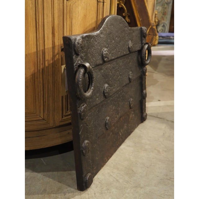Cast in the 1800s in the Medieval style, this robust French iron fireback features thick horizontal, lapped plates that...