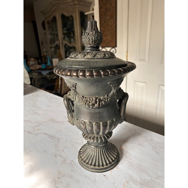 Beautiful cast black stone garden ornament in revival rococo style. These urns are highly sought after by designers and...