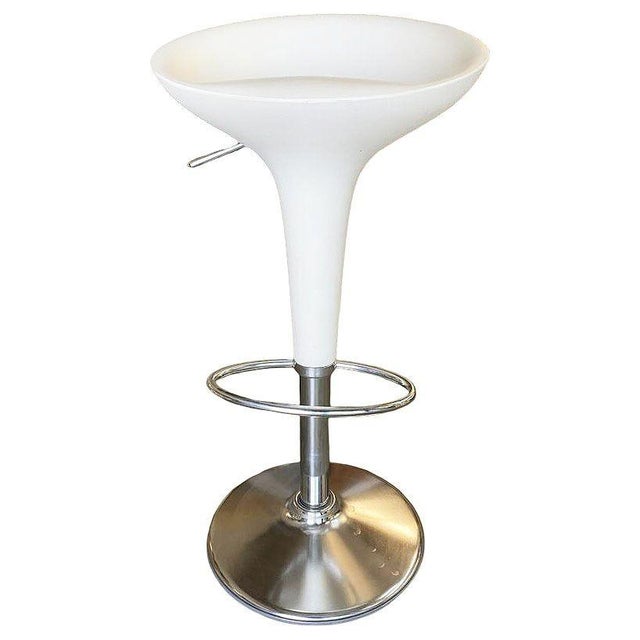 Philippe Starck-style white modernist stool and table set featuring white plastic tops and chromed steel bases. The set...