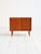 Teak cabinet with sliding doors and recessed handles, tapered legs with brass tips. Scandinavian production from the...