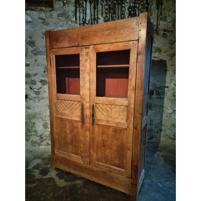 French cupboard dating from the early 19th century, originating from the Auvergne region. The piece is constructed from...