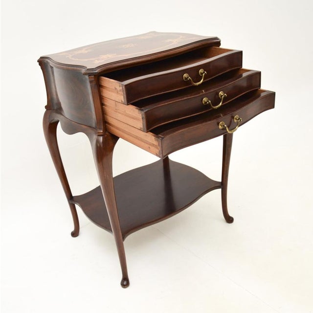 A smart and extremely well made antique inlaid walnut side table by Waring and Gillow. This was made in England, it dates...