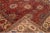 Beautiful Antique Sultanabad hand-knotted wool rug with a red color field. This rug has a beige frame and multicolor...