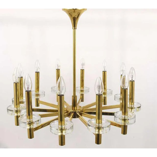 An outstanding Italian brass and crystal glass chandelier from the 1970s, in the manner of Gaetano Sciolari. Has 12 arms,...
