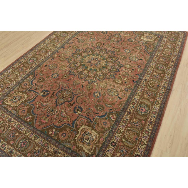 An authentic vintage traditional Mashad rug hand-knotted with fine wool and natural dyes. This oriental rug features a...