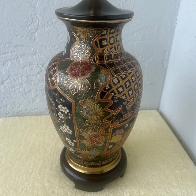 The lamp features intricate multicolored tapestry style hard painted floral panels with textured raised enamel detailing