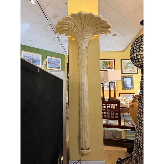 Elevate your space with this dramatic, sculptural pair of vintage Hollywood Regency palm tree torchiere lamps. Modeled...