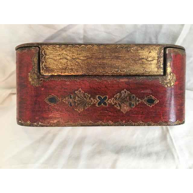 Small red and gold painted wooden box. Made in the 1800s - designed for playing cards and gambling chips.