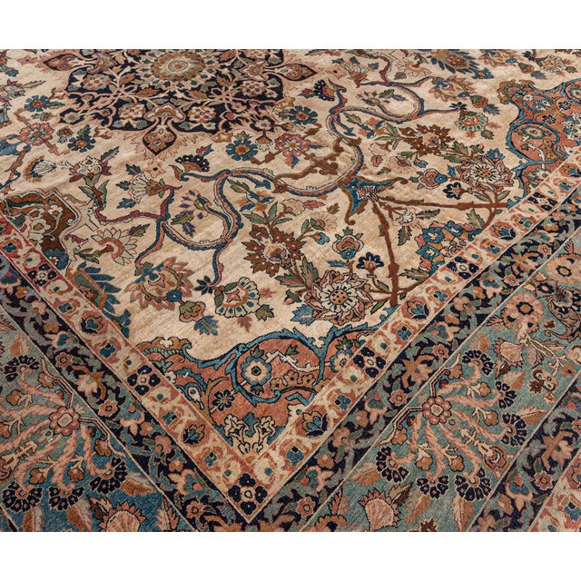 An early 20th century Persian rug patterns, the caramel field with playful scrolling flowering vines framing two black...