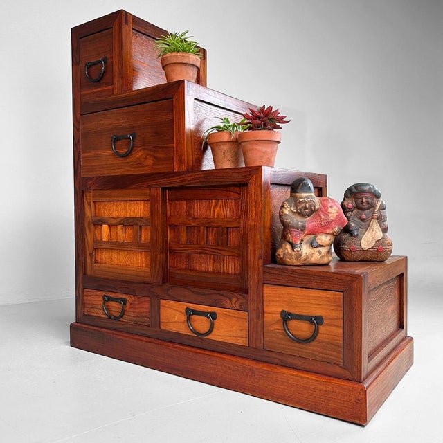 This exquisite Kaidan Dansu (階段箪笥), a traditional Japanese step chest, dates back to the 1970s-’80s and is crafted from...