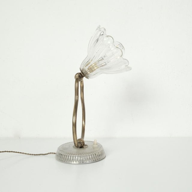 Wonderful table lamp, original production from the mid-20th century. Circular base in glass-effect plastic, brass...