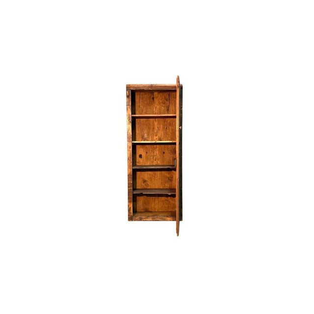 A single-door cabinet made of fir wood, dating back to the early 1900s. with its simple, essential lines, it features a...