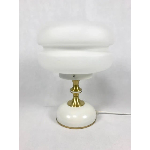 Mid-Century Milk Glass and Brass Table Lamp from Napako, 1960s, in Flawless conditions. Designed 1970 to 1979 This piece...