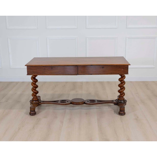 A handsome 19th century Victorian writing table crafted from richly toned wood and featuring beautifully turned barley...