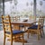 A cohesive set of six vintage mid-century modern dining chairs pairing sculpted ladderback frames with newly upholstered...