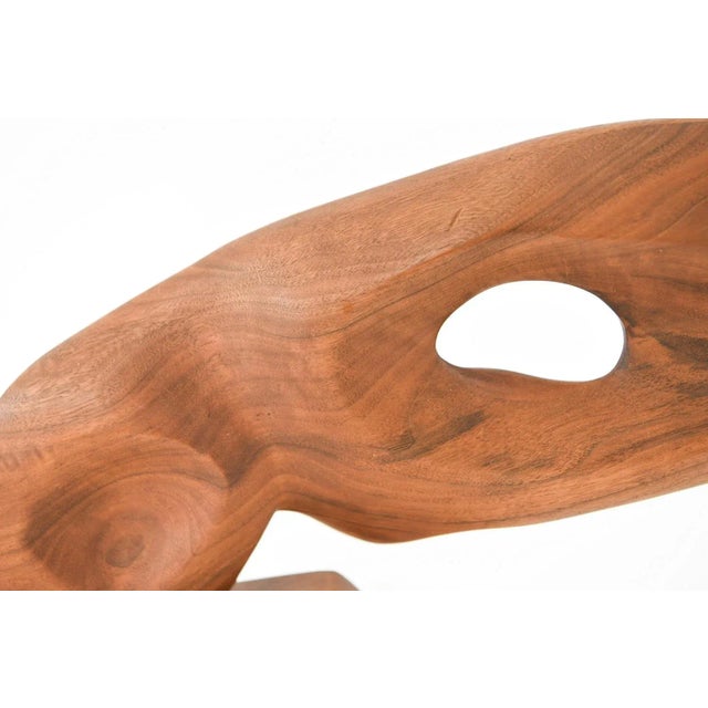 Kiki Brodkin (1926 - 2010) was an American artist. This piece is an Untitled sculpture made of mahogany. 11 x 22 x 3 in....
