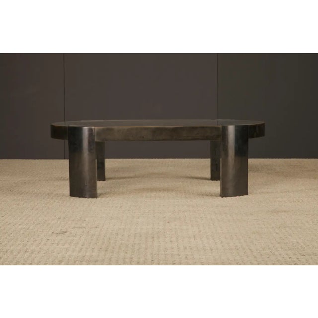 A commanding and sculptural 'Banker' bronze coffee table by celebrated American designer Karl Springer, dating to the...