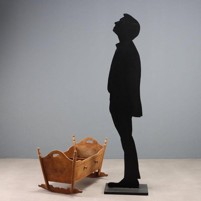 A fruitwood cradle with maple trim and violetwood sides. Italy, mid-19th century. This piece is attributed to the...