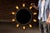 A dramatic circular illuminated mirror framed in hand-wrought iron, designed in a bold sunburst configuration. The mirror...
