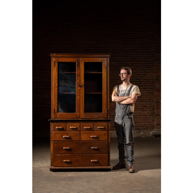 An early 20th century laboratory cabinet manufactured by Kewaunee Mfg. Co., who are still around today making cabinets all...