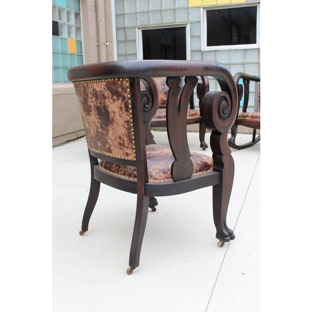 Indulge in Timeless Elegance with an Antique Empire Mahogany Ball Claw Rolled Arm Chair Transport yourself to a bygone era...