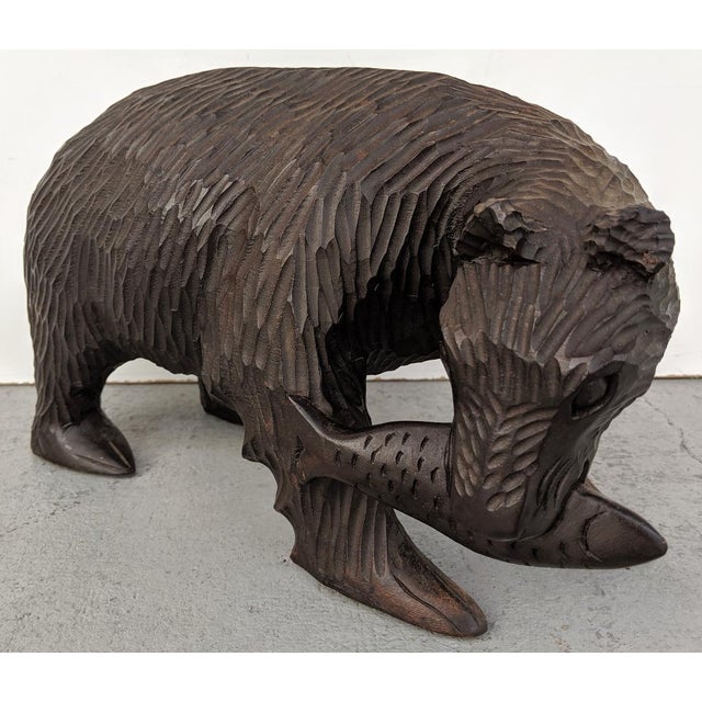 This a great hand-carved wooden bear, that has just caught a large fish. The manor in which the bear has been carved out...