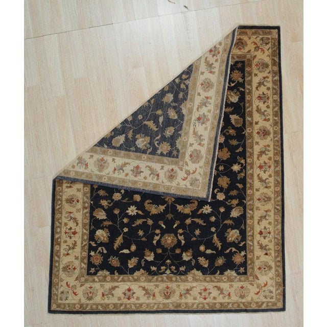 This hand knotted pile rug is crafted from wool and features a primary blue color palette. The design reflects the...