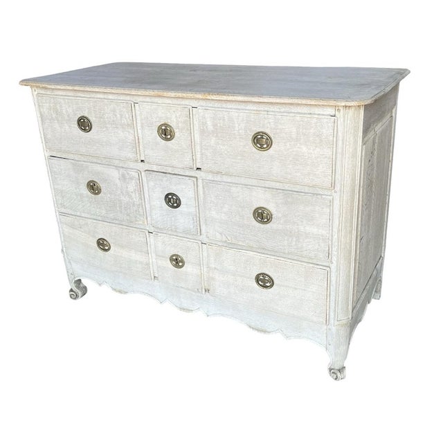 Louis XV commode hand-made in France in the early 1800s using oak. The commode features three rows of overlay drawers, on...